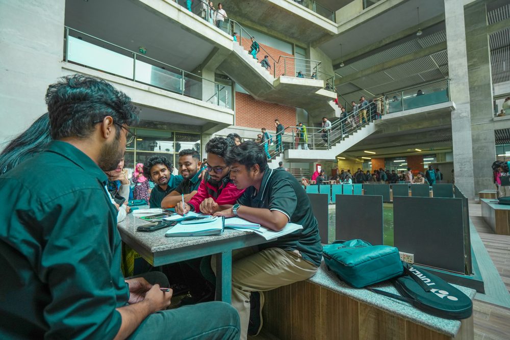 Students studying together at a table in the UIU atrium
